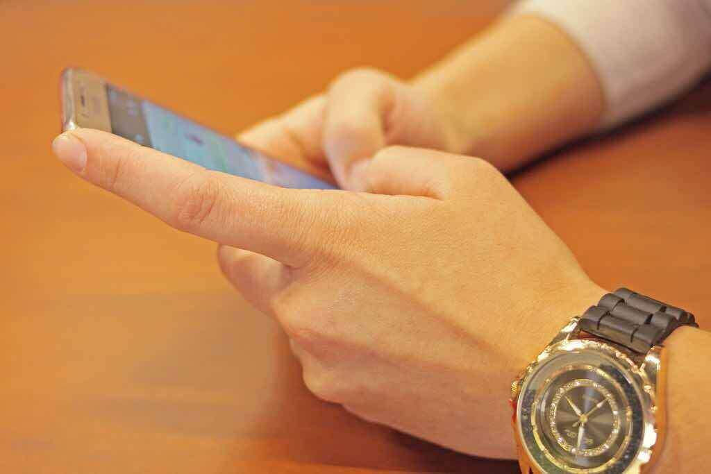 Men uses writing software for writing a message on a smart device