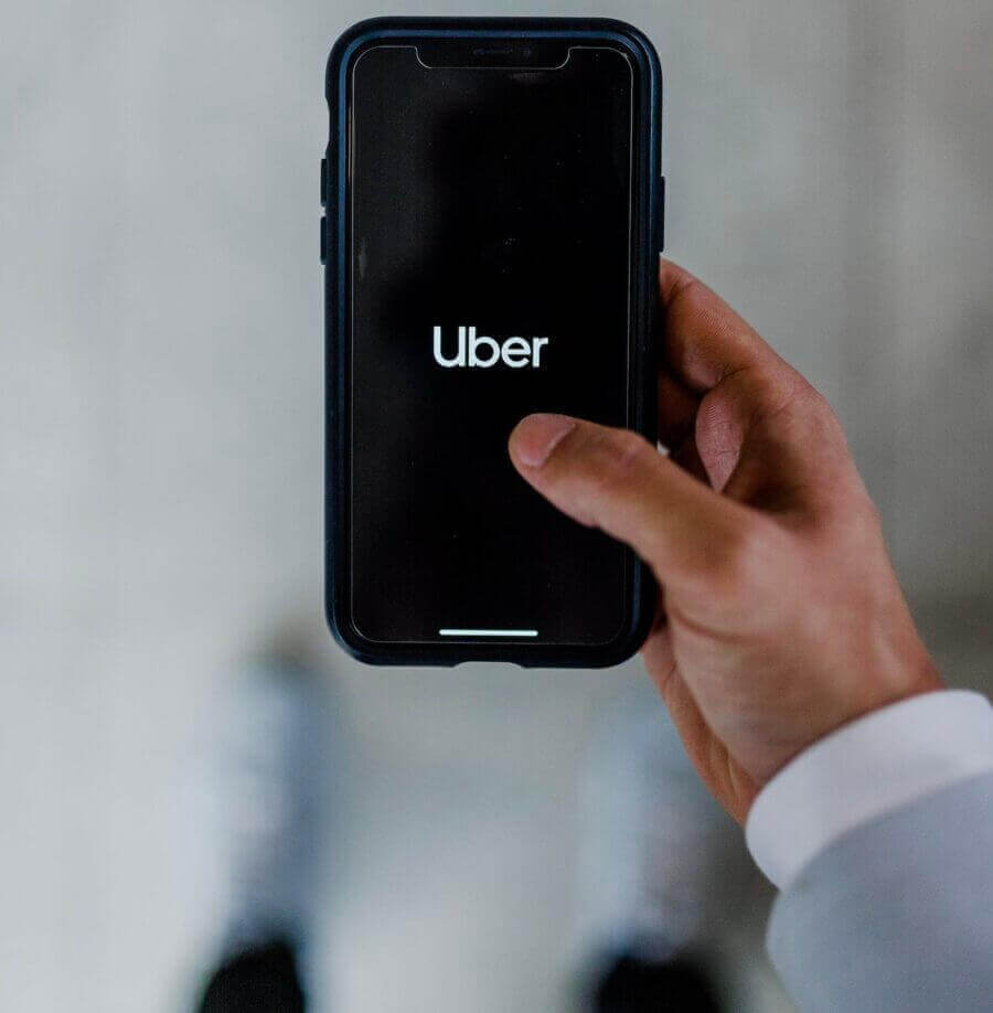 Uber app in the hand of a business person